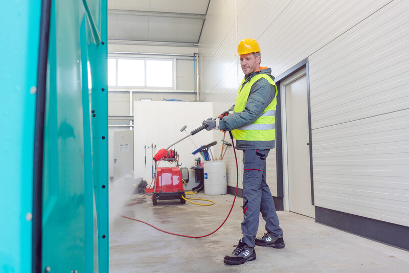 Man Cleaning Portable Toilets